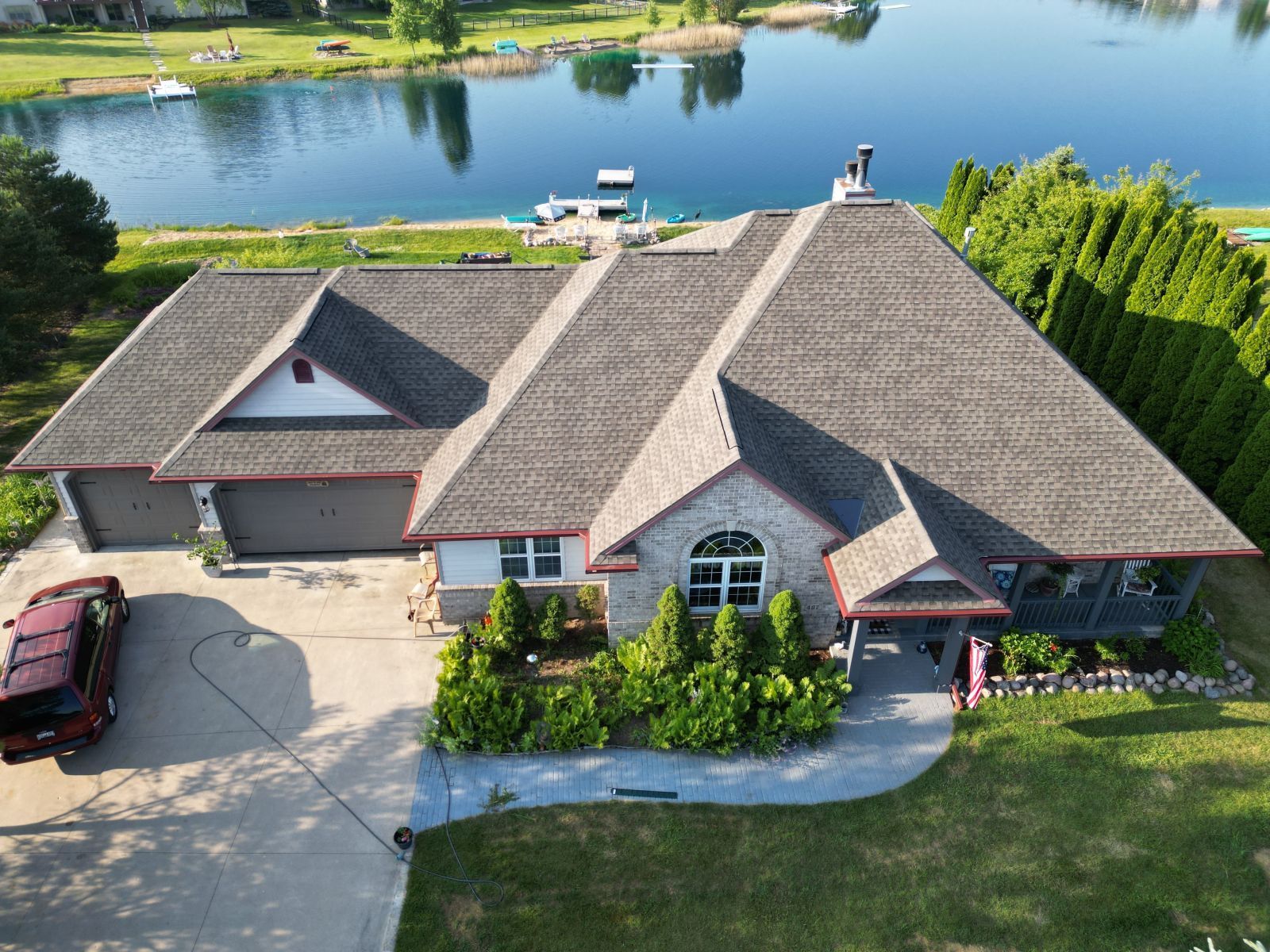 An aerial view of a large house with a car parked in front of it.