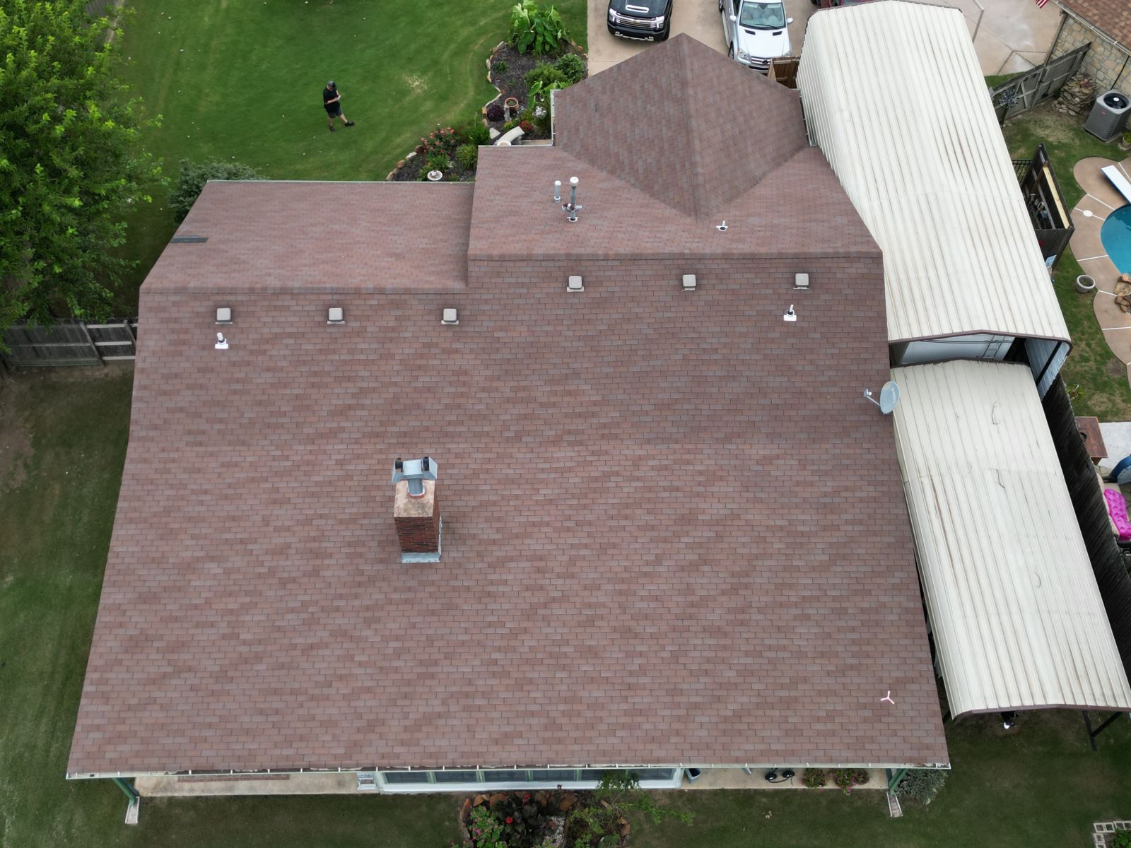 An aerial view of a house with a brown roof.