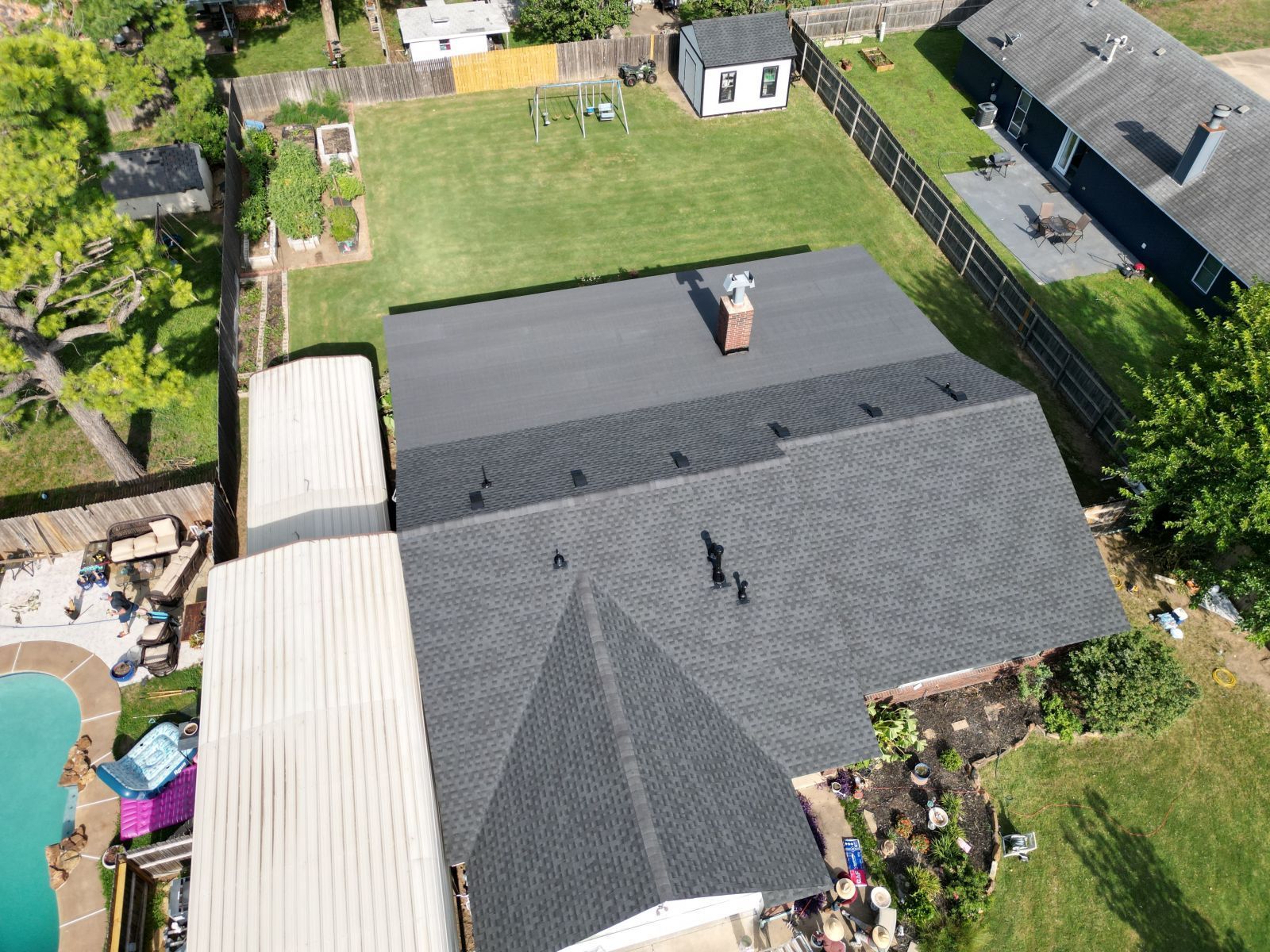 An aerial view of a house with a roof that has been installed.