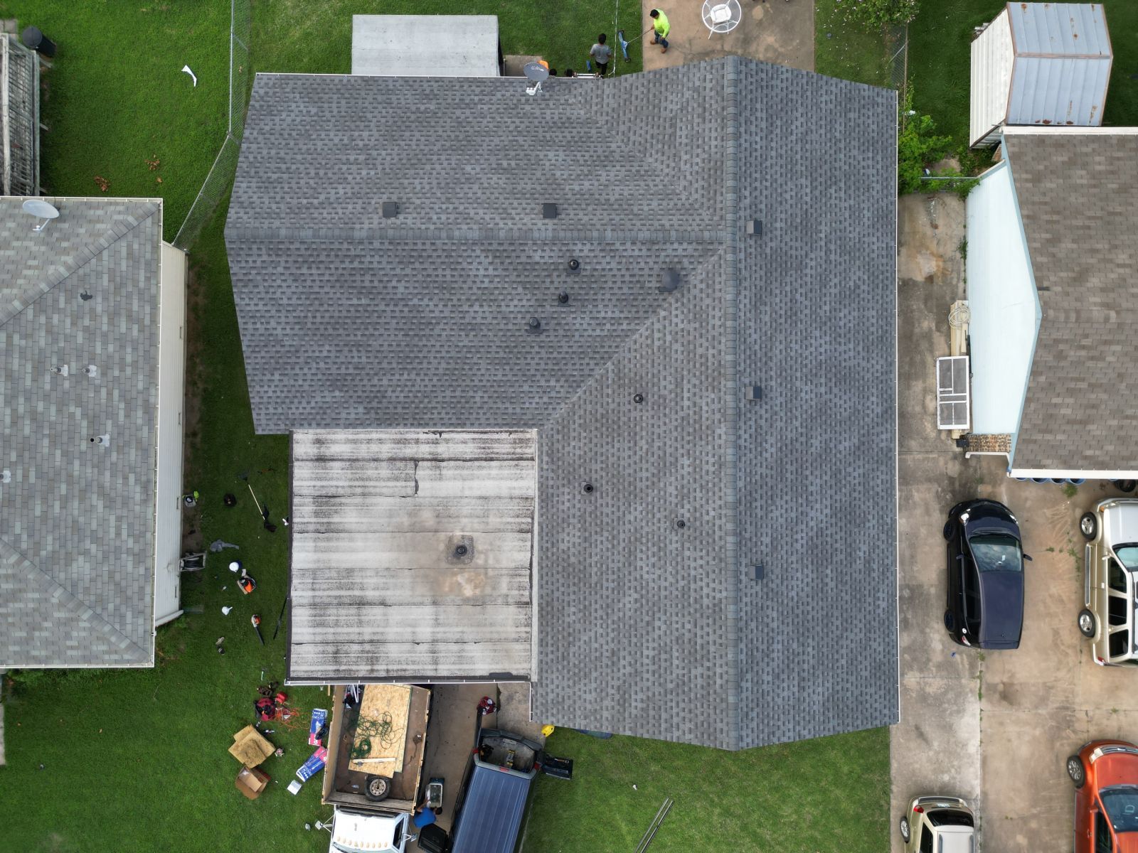 An aerial view of a house with a roof that is being repaired.