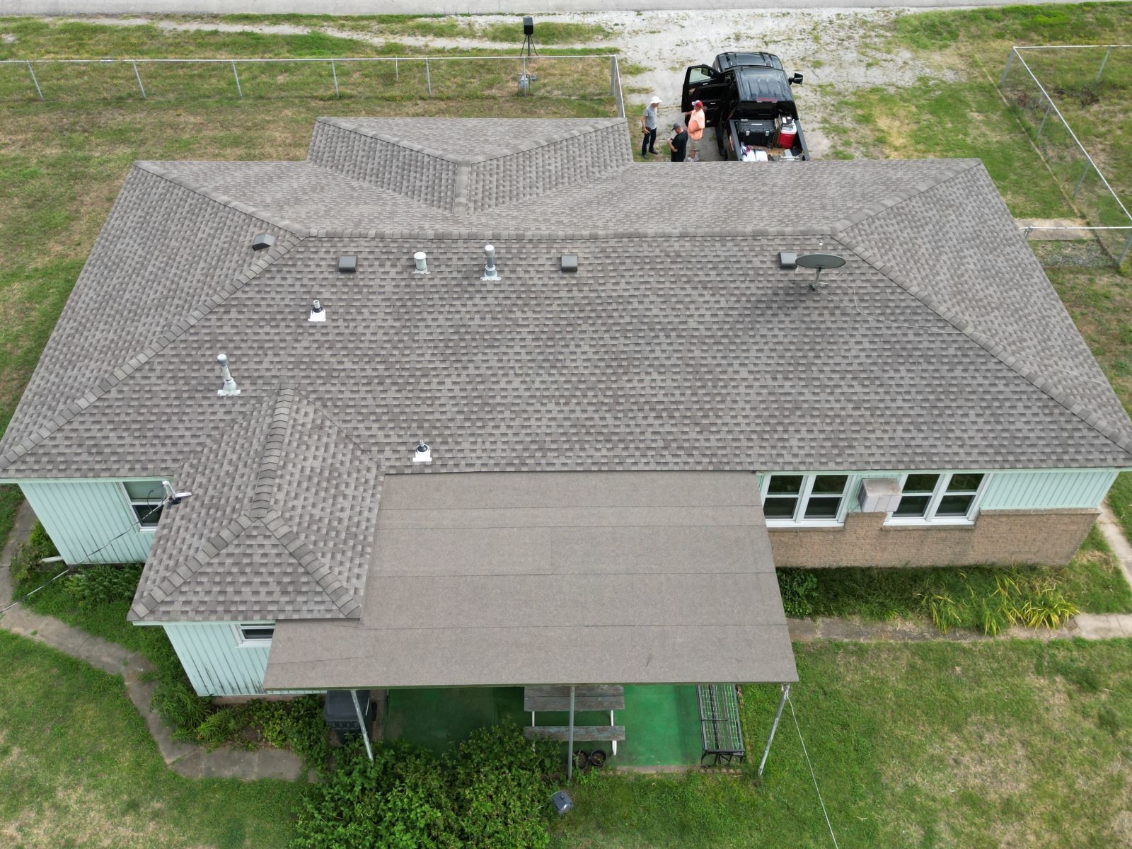 An aerial view of a house with a car parked in front of it.