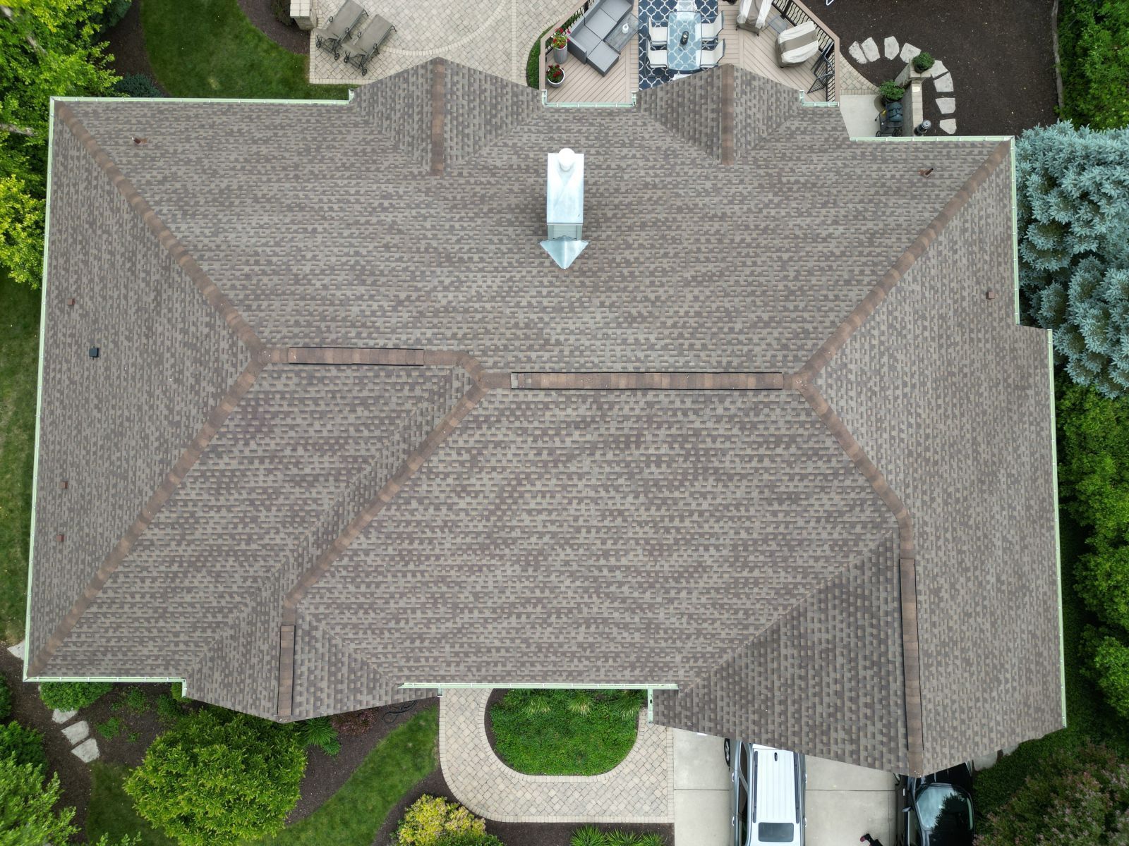 An aerial view of a large house with a car parked in front of it.