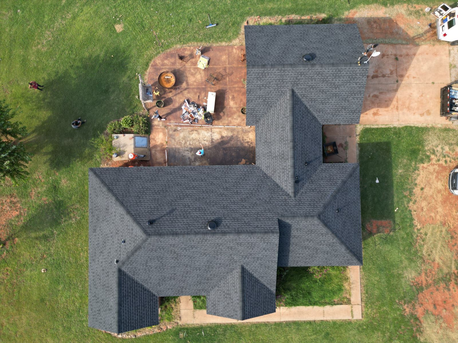 An aerial view of a house with a black roof