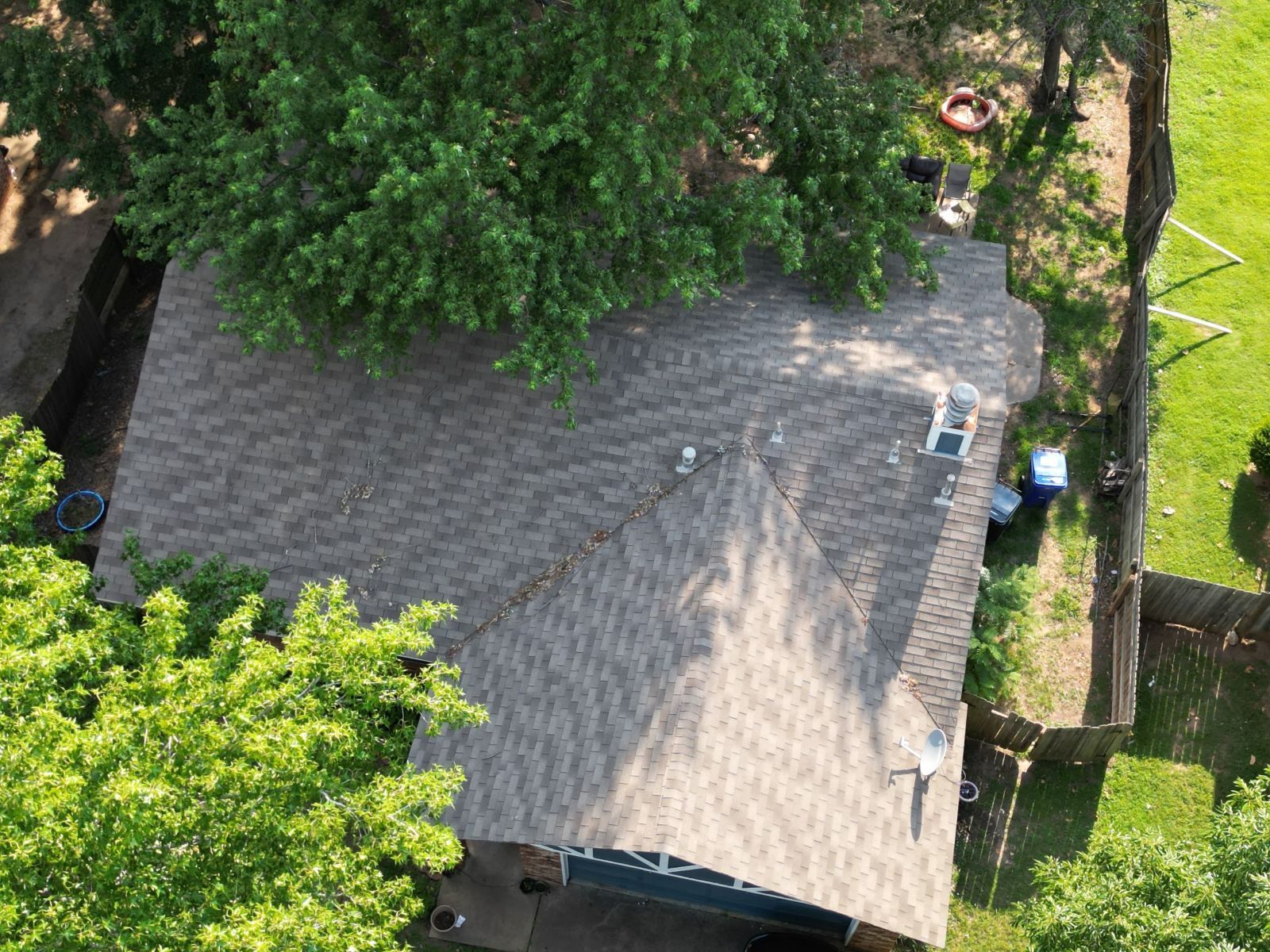An aerial view of a house with a roof and a garage