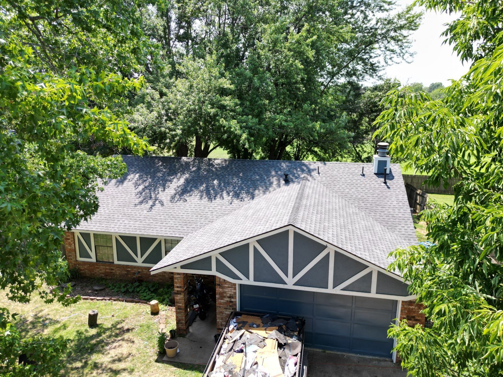An aerial view of a house with a truck parked in front of it.