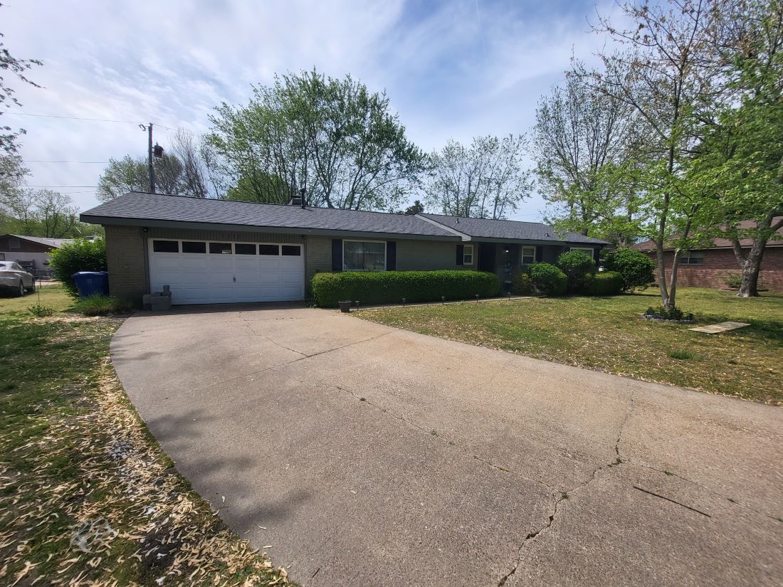 A driveway leading to a house with a garage
