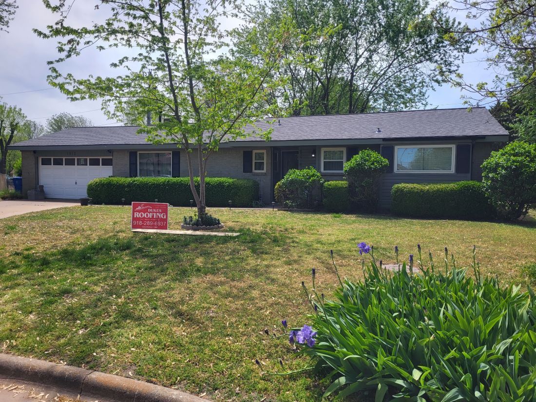 A house with a for sale sign in front of it