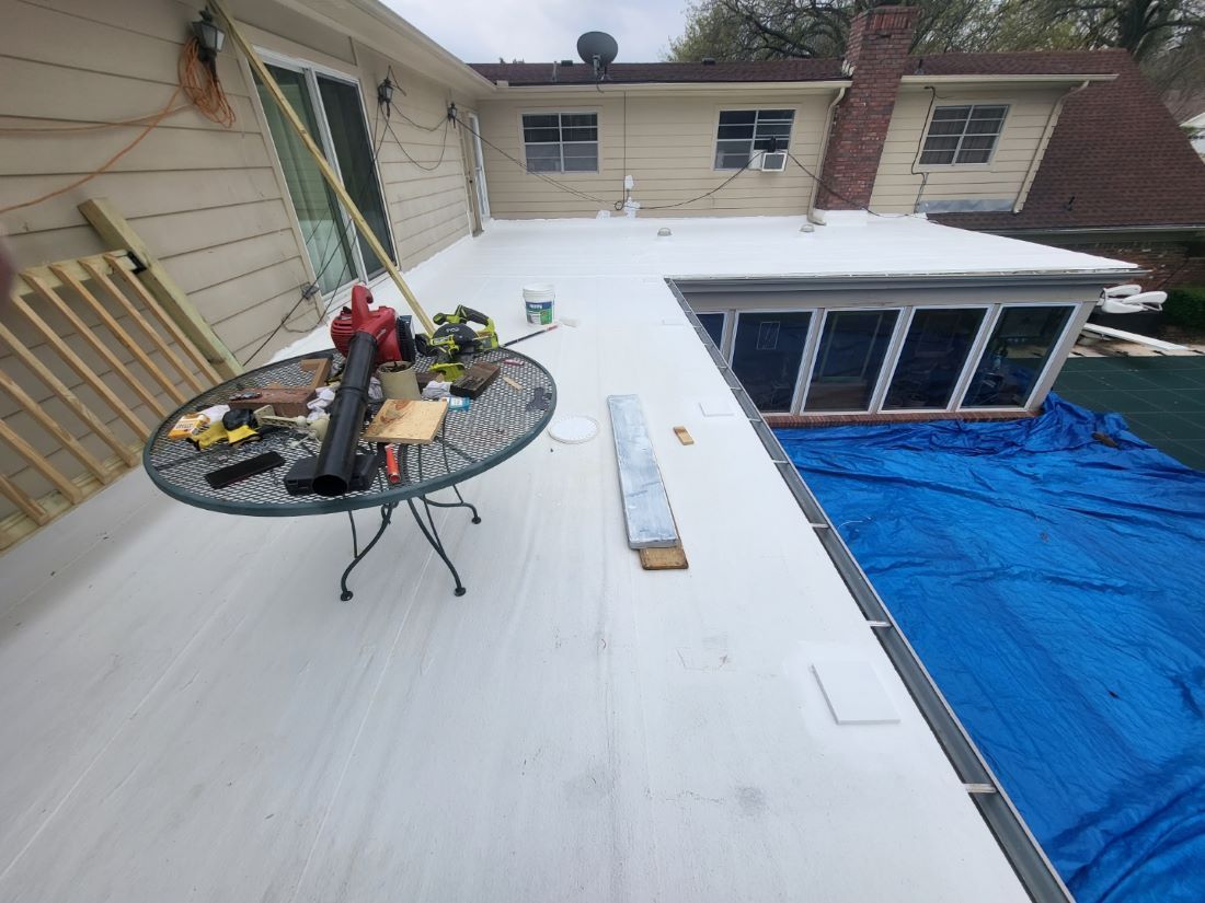 A white deck with a table and tools on it