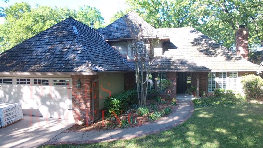 A large house with a roof that has shingles on it