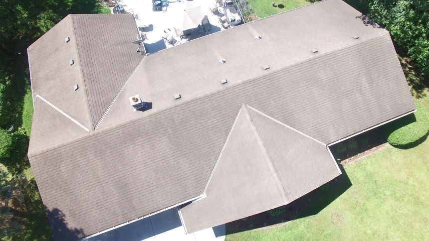 An aerial view of a house with a large roof