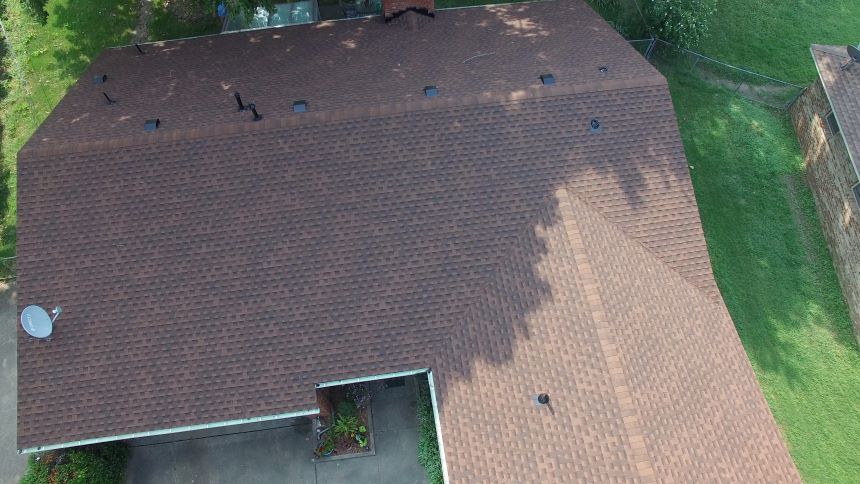 An aerial view of a house with a brown roof.