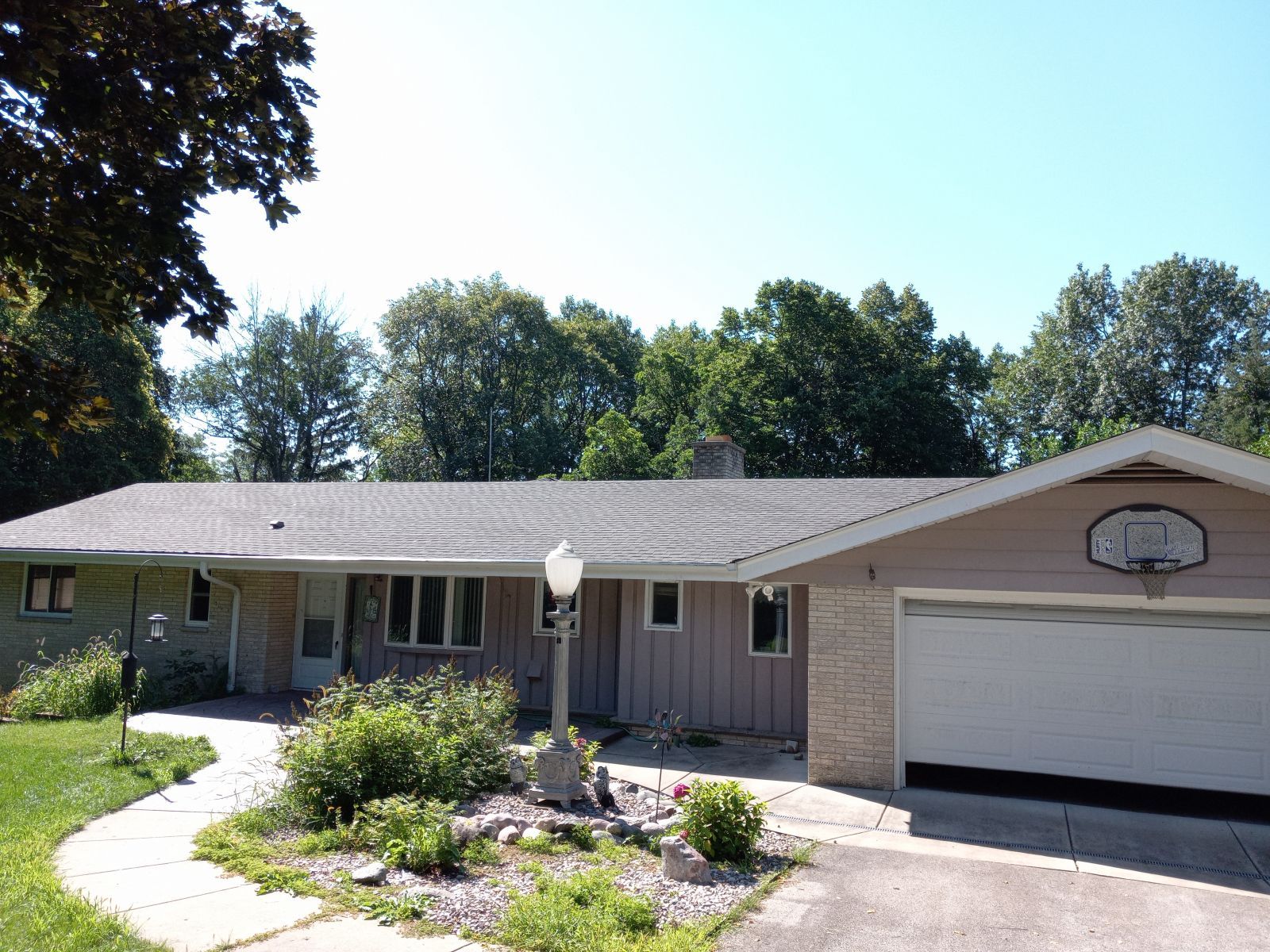 A house with a basketball hoop on the side of it