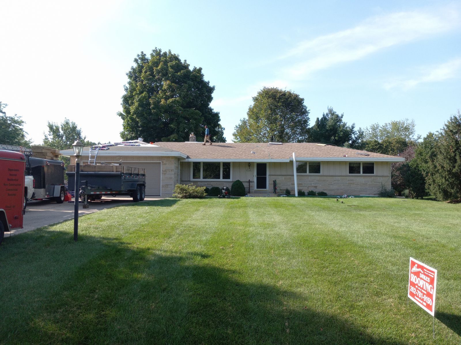A house for sale with a sign in front of it