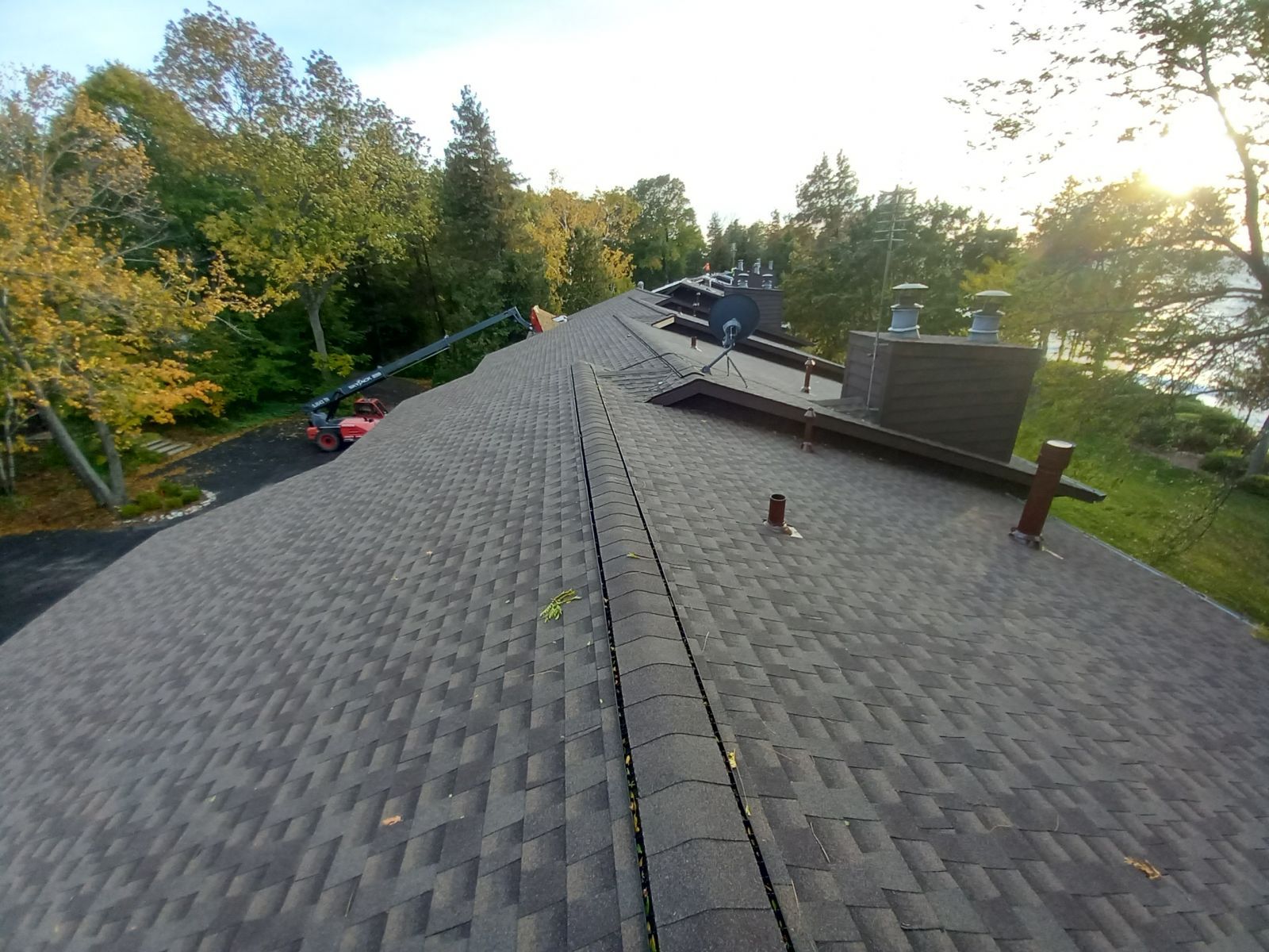A roof with a lot of shingles and chimneys on it