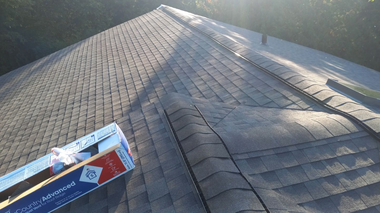 A box of aluminum foil is sitting on top of a roof.