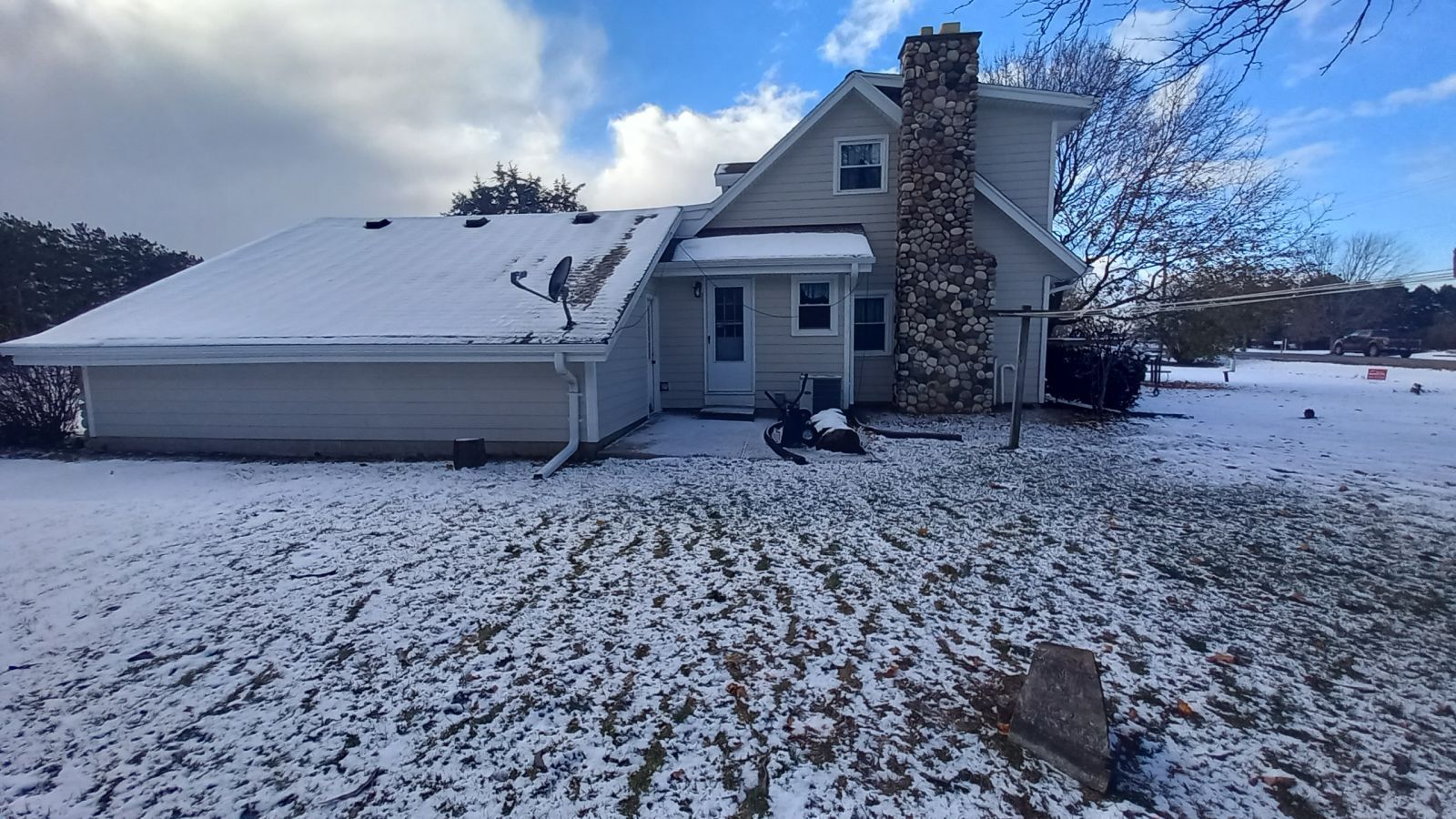 A house is covered in snow on a sunny day