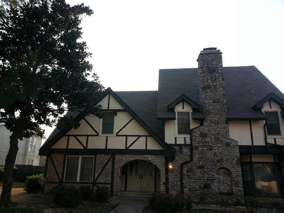 A large house with a chimney on the roof