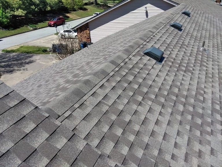 The roof of a house has a lot of shingles on it.
