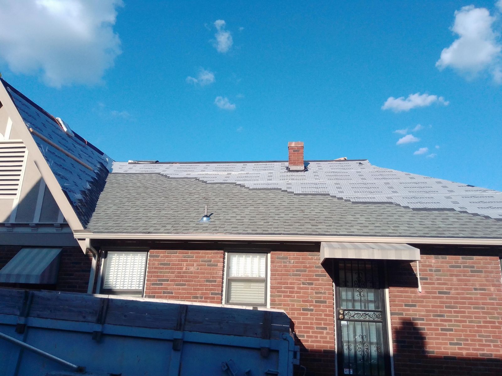 A brick house with a chimney on the roof