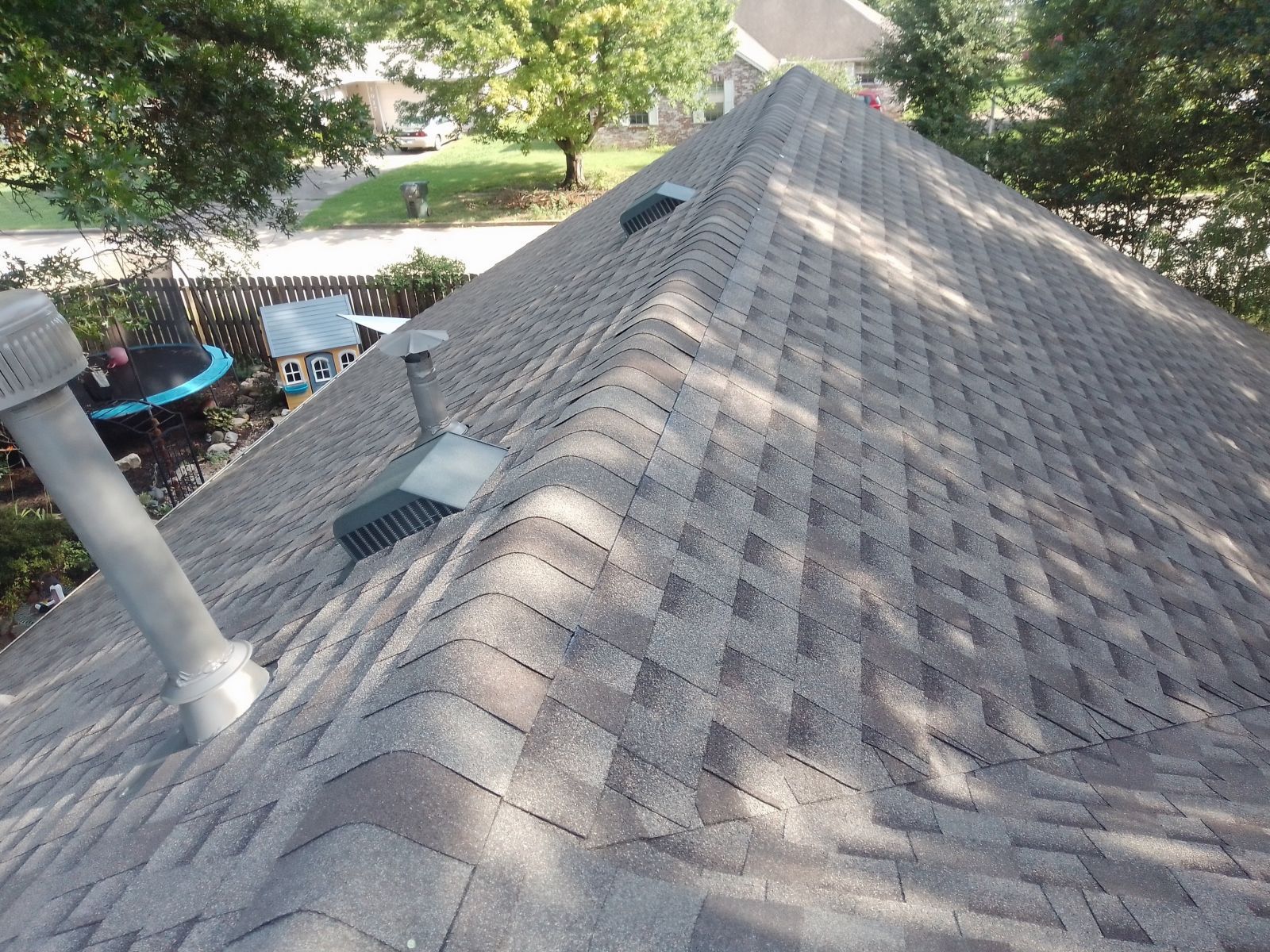 The roof of a house has a lot of shingles on it