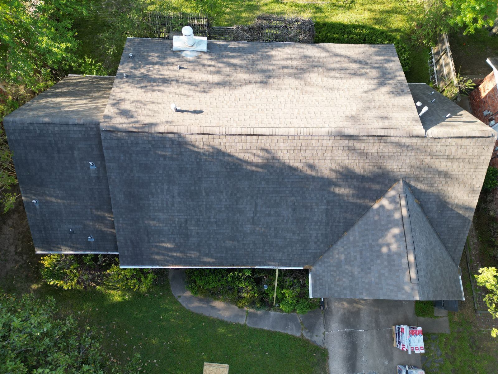 An aerial view of a house with a roof that is covered in shingles.