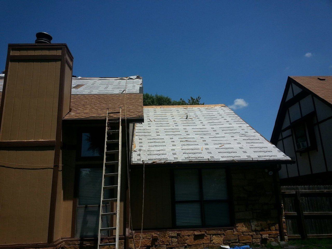 A house with a ladder attached to the side of it