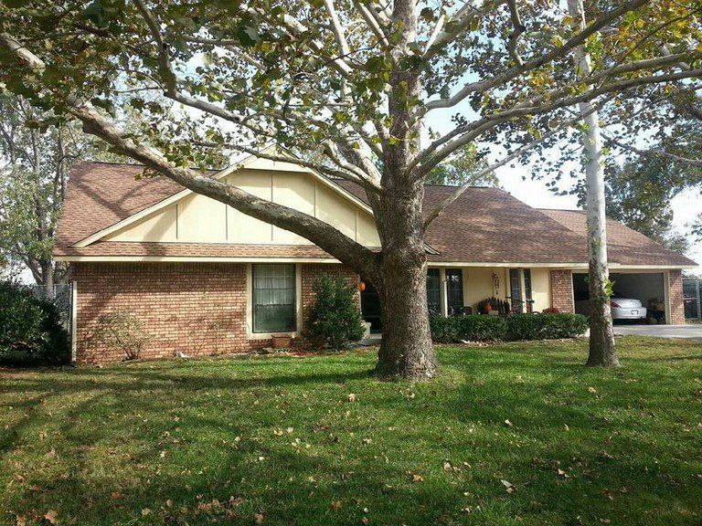 A brick house with a tree in front of it