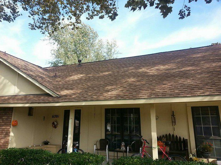 A house with a brown roof and a porch