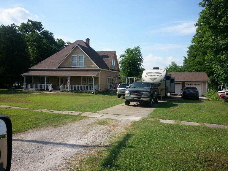 A house with a trailer parked in front of it