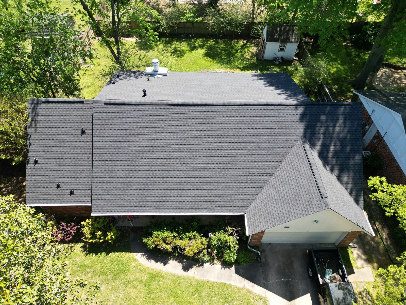 An aerial view of a house with a black roof