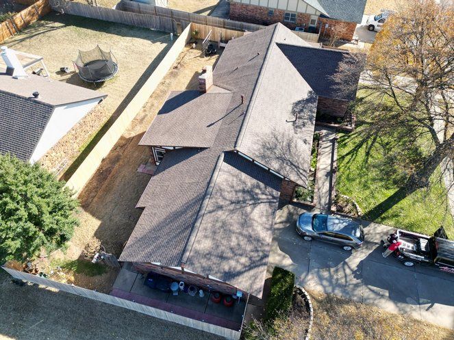 An aerial view of a house with a car parked in front of it.