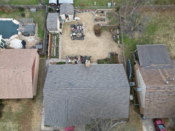 An aerial view of a house with a pool in the backyard.