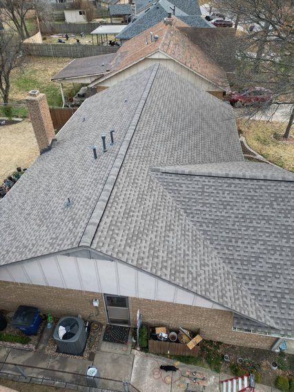 An aerial view of a house with a new roof.