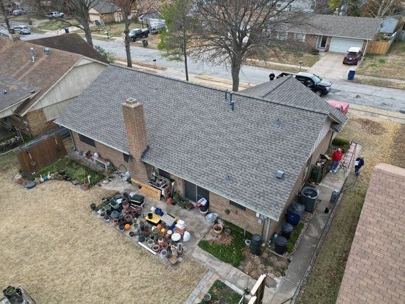 An aerial view of a house with a roof and a chimney.