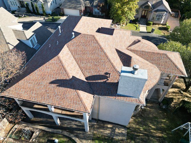 An aerial view of a house with a brown roof
