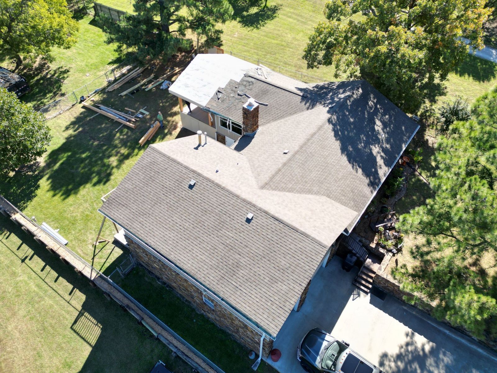An aerial view of a house with a car parked in front of it.