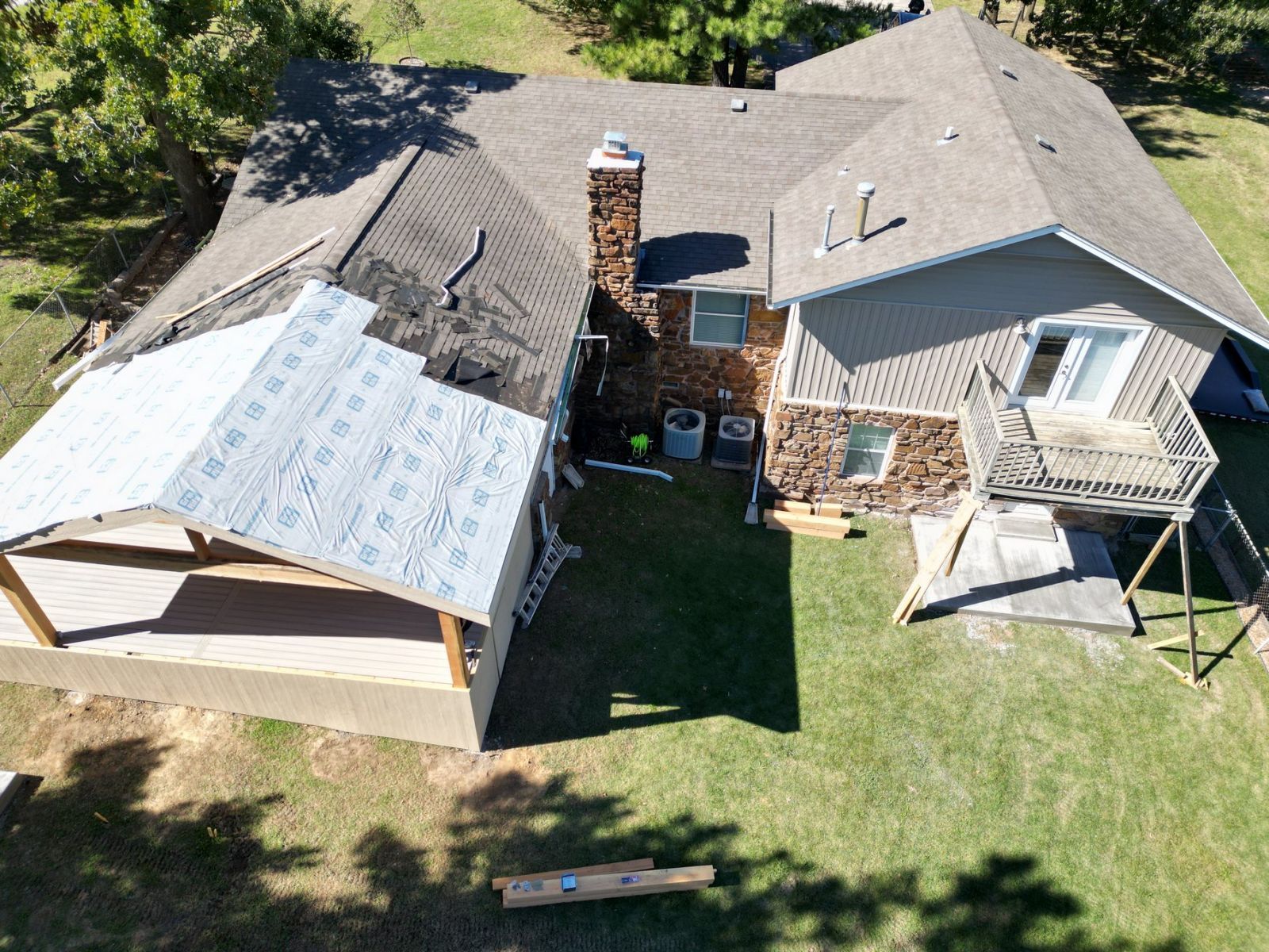An aerial view of a house with a roof being installed.