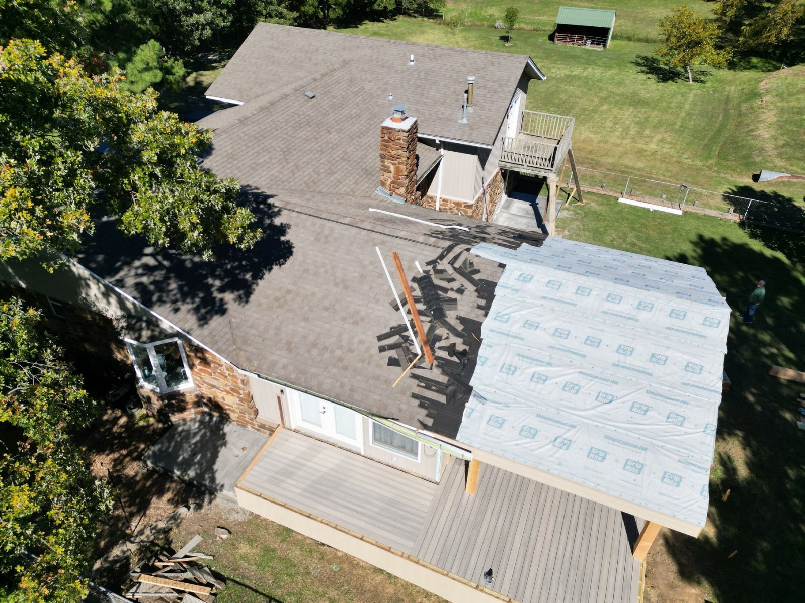 An aerial view of a house with a roof that is being installed.