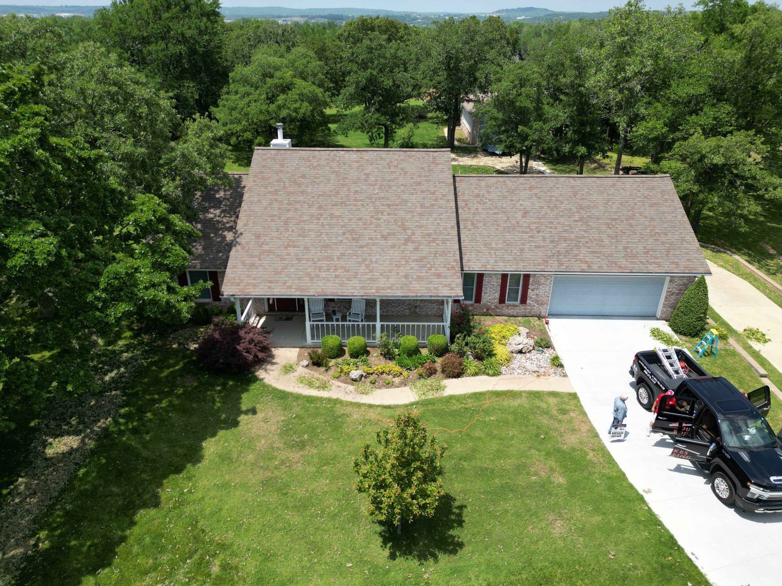 An aerial view of a house with a truck parked in front of it.