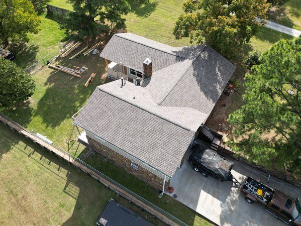 An aerial view of a house with a car parked in front of it.