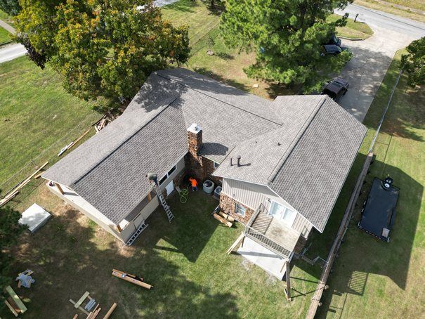 An aerial view of a house with a roof that is being installed.