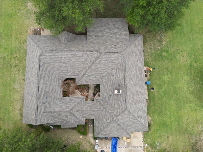 An aerial view of a house with a roof that has a hole in it.