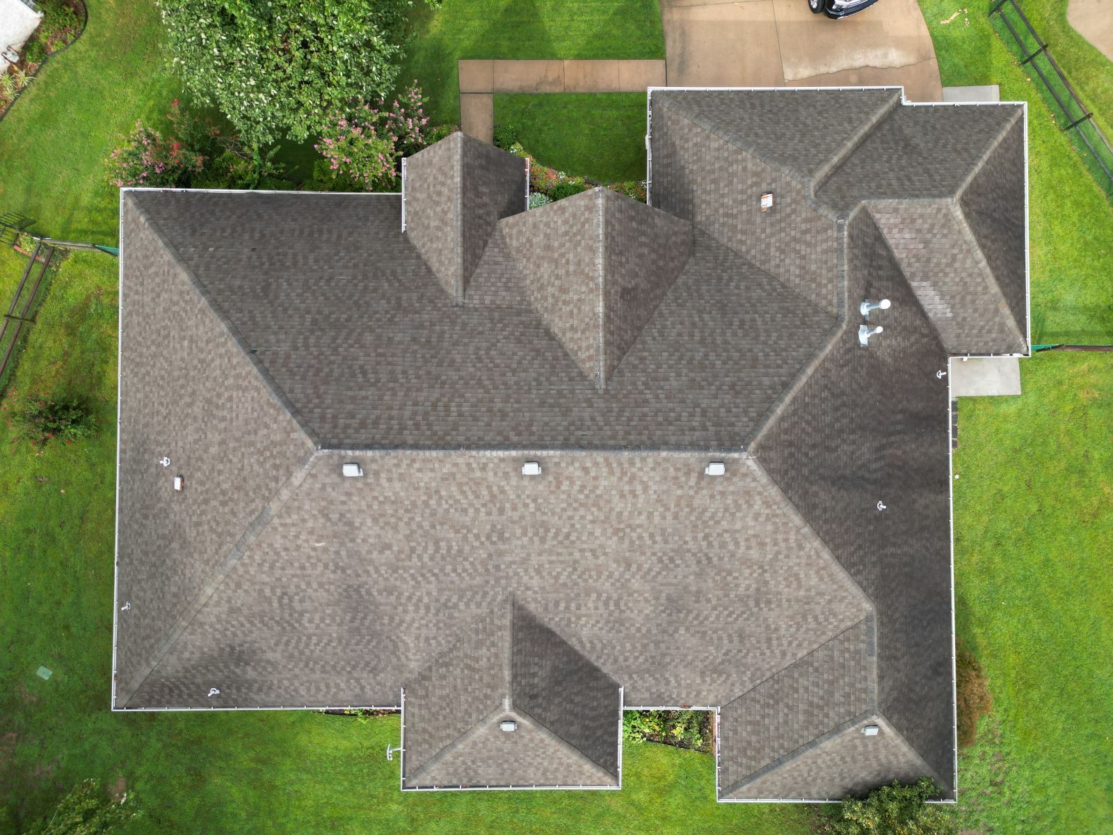 An aerial view of a large house with a gray roof.
