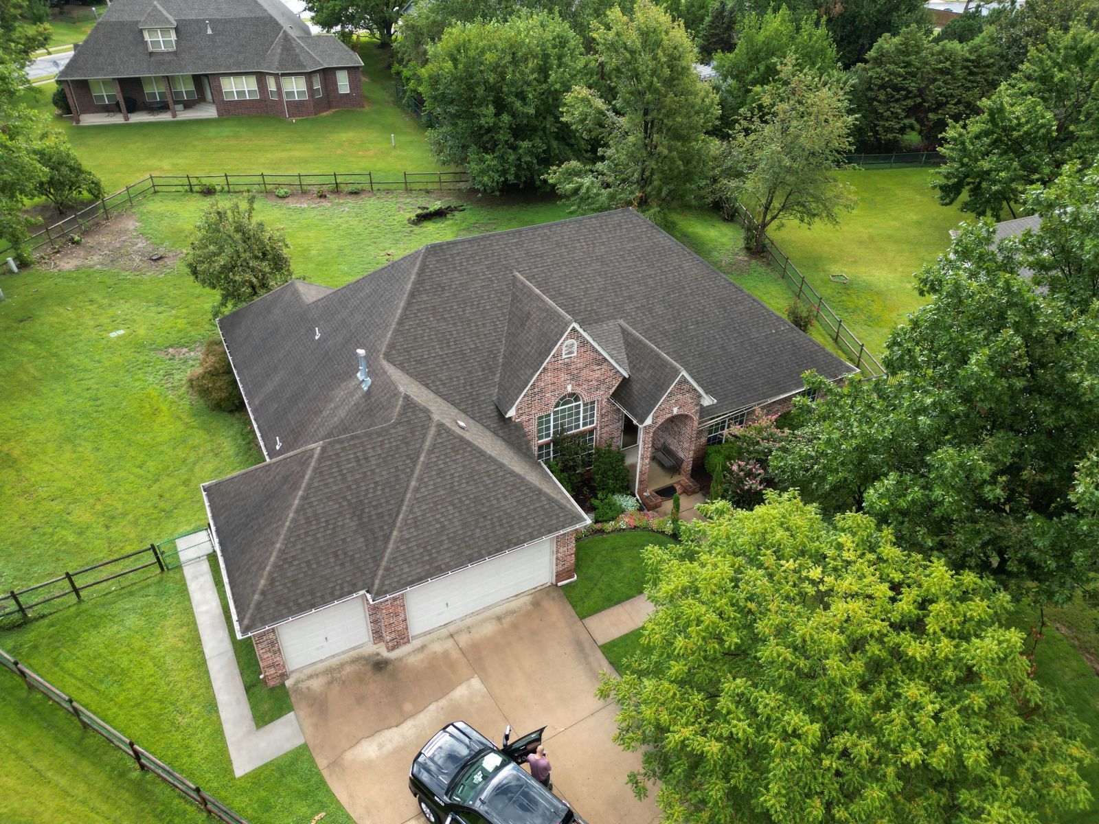 An aerial view of a house with a truck parked in front of it.
