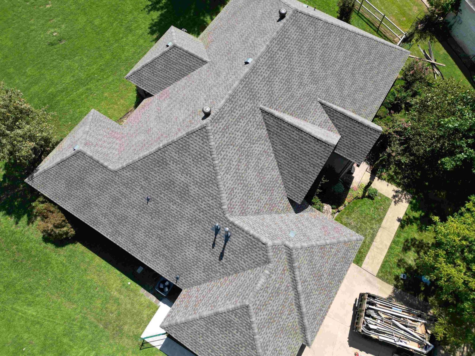 An aerial view of a large house with a gray roof.