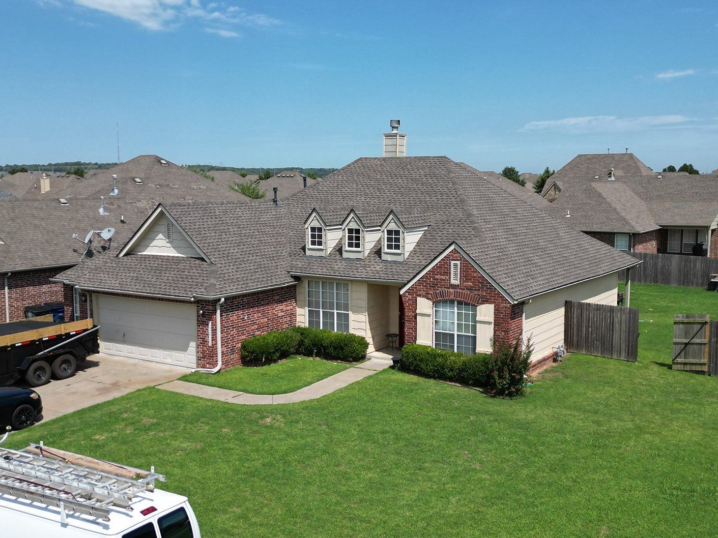 An aerial view of a house with a truck parked in front of it.
