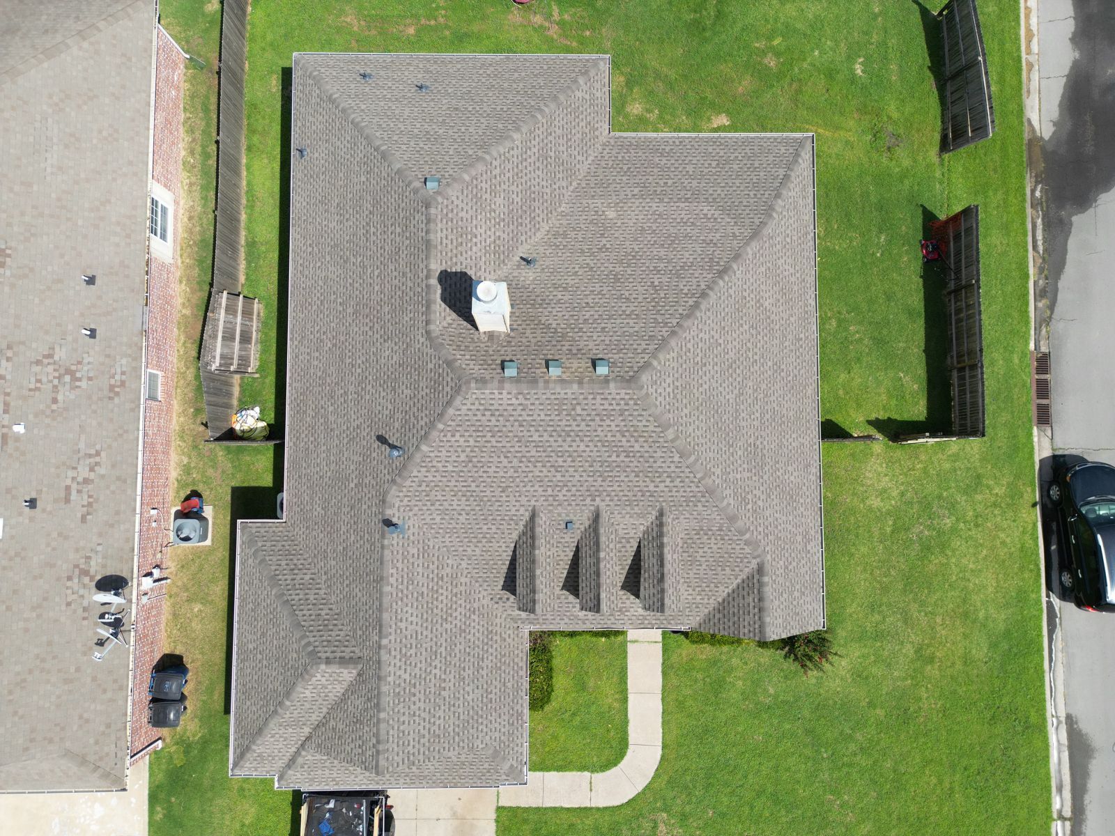 An aerial view of a house with a roof that is covered in shingles.
