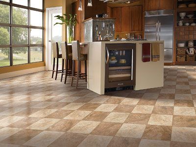 A kitchen with a checkered floor and a large island.