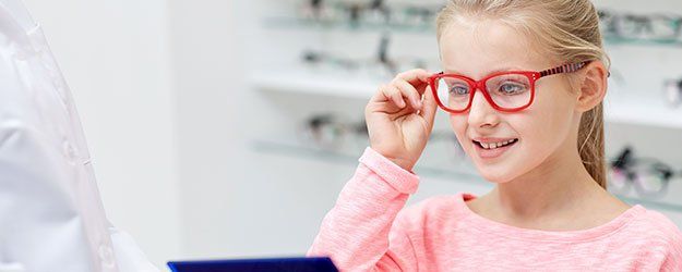 child with red framed glasses
