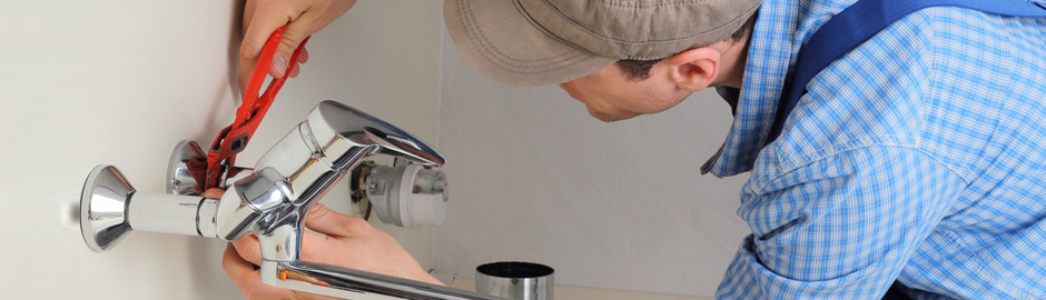 Plumbing service technician repairing faucet